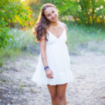 portrait of young woman in white dress at Gilson beach