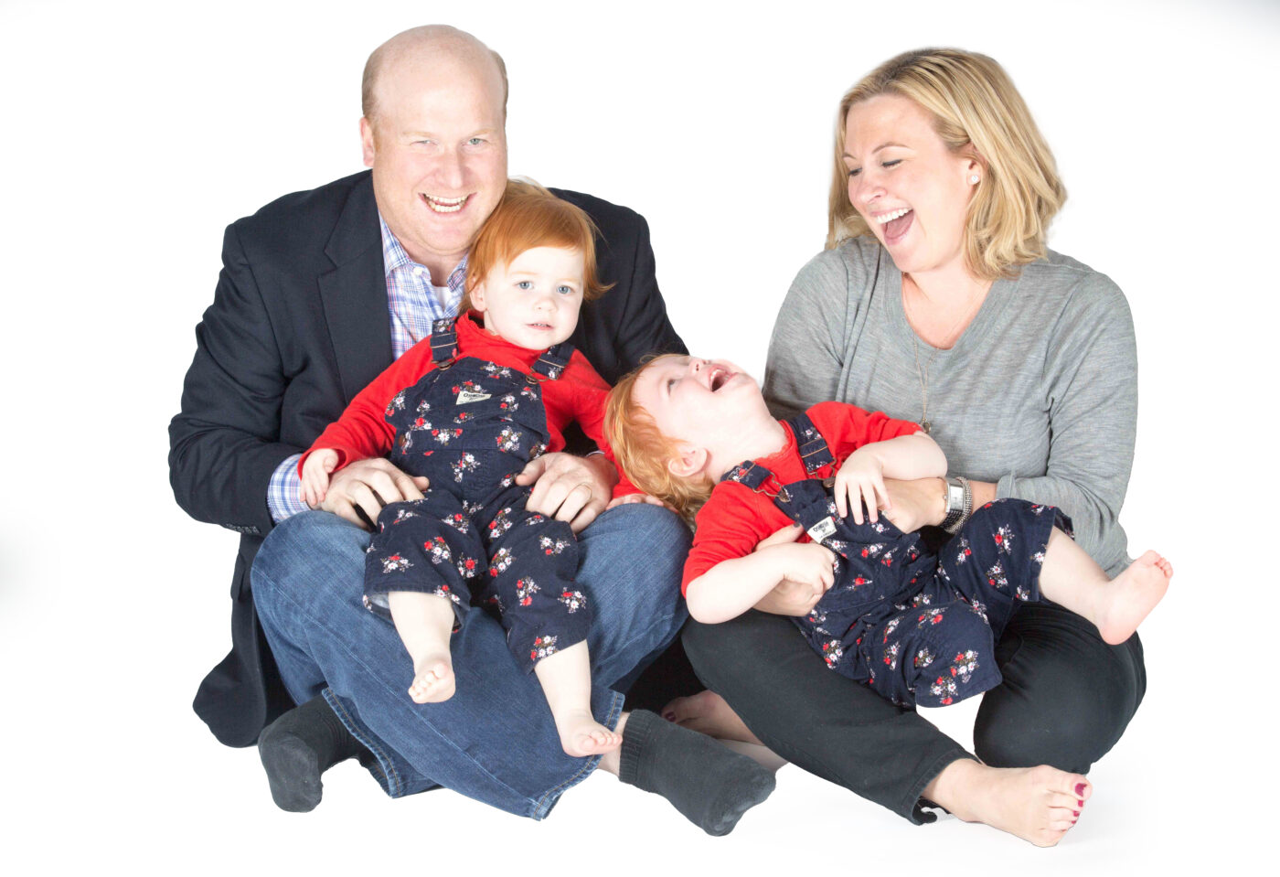 Family portrait taken in studio with white backdrop